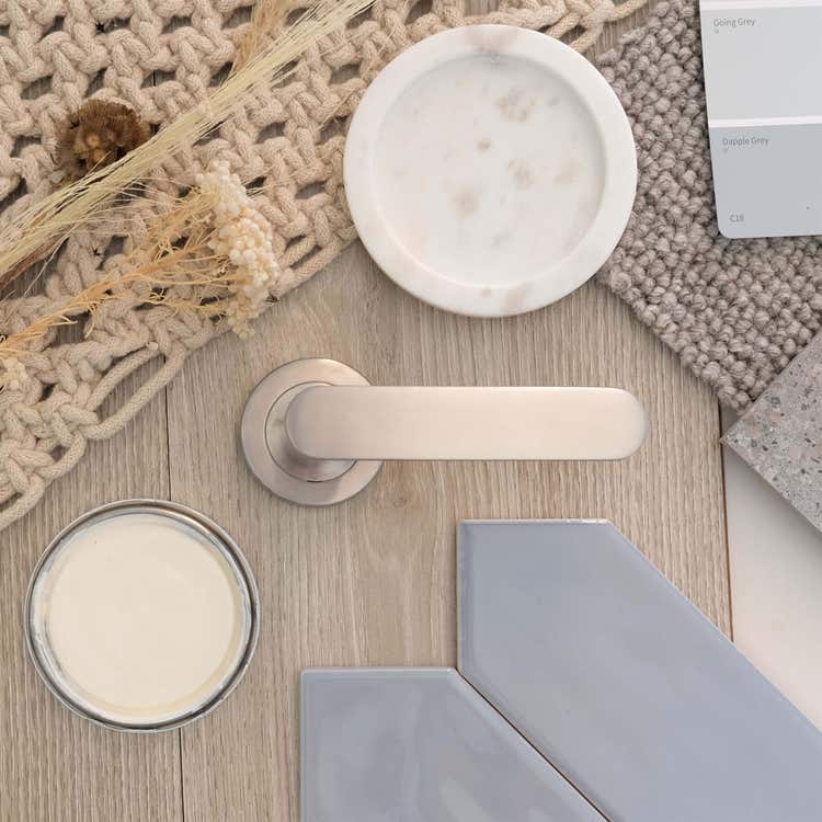 Stainless steel door handle with material samples and textiles